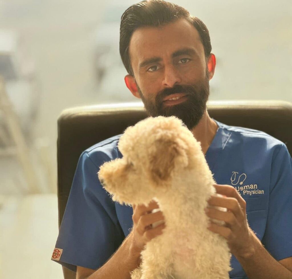 Dr Ali Usman holding a Dog in hand